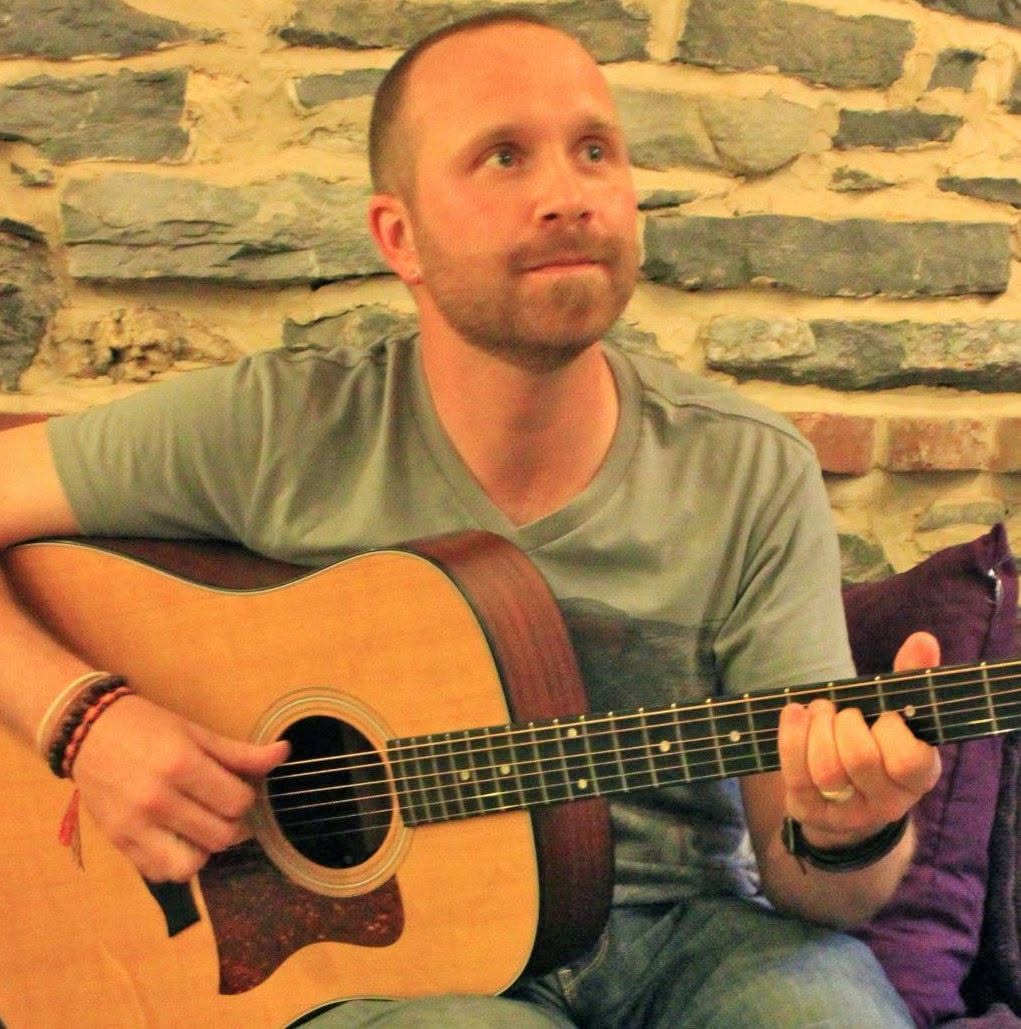 Mark DeRose Singer and Songwriter - Mark holding a guitar