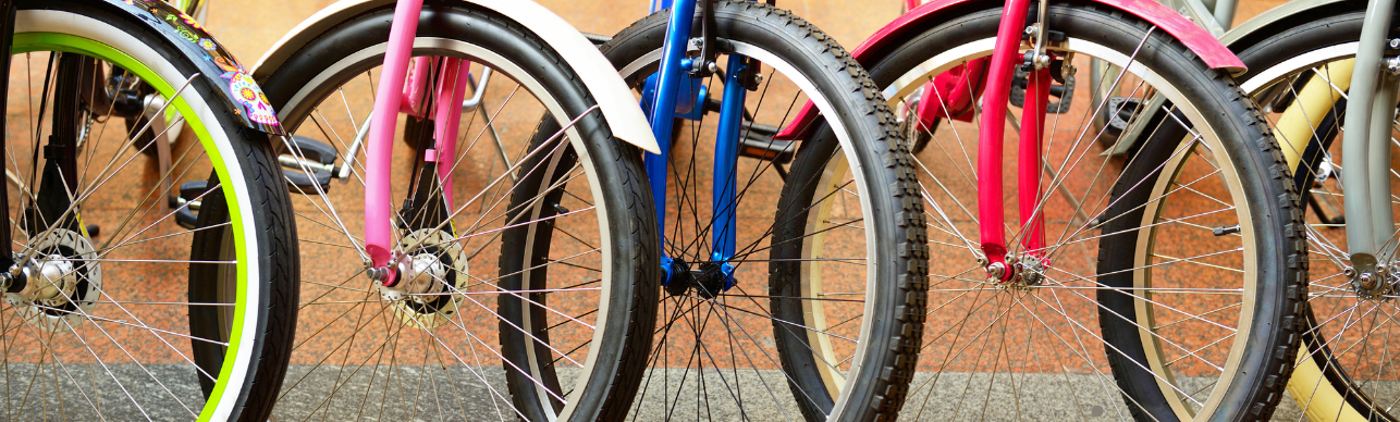 Graphic of several brightly colored bicycle wheels lined up in a row