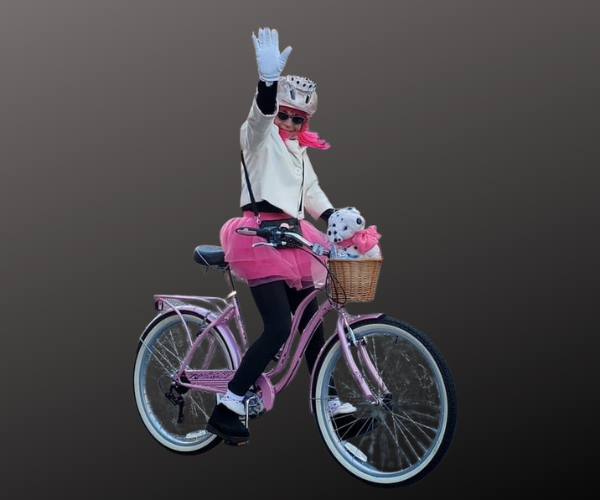 Biker Barbie on a pink beach cruiser bicycle