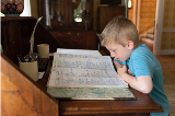 Child looking at historic book