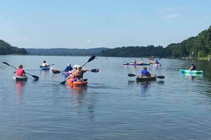 Group of people paddling down the Susquehanna river in kayaks