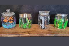 Painted glass jars with different designs.