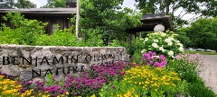 Picture of the Benjamin Olewine Nature Center with colorful wildflowers