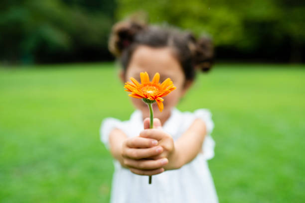 child holding a flower