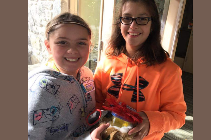 Two Girl scouts showing off their projects