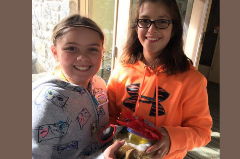 Two Girl scouts showing off their projects