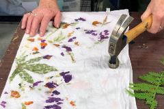 Pillow cased with colored flowers pounded into it for design