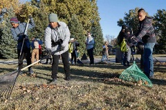 Group of people raking leaves