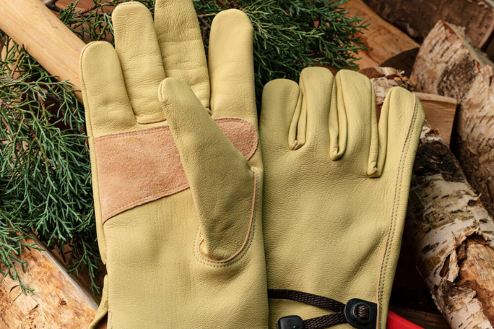 Work Gloves on a background of wood and leaves