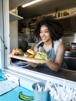 Woman serving food through a food truck window