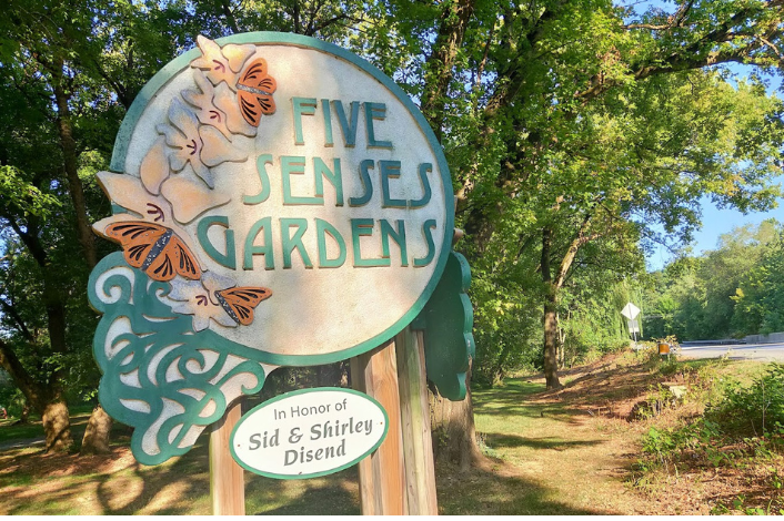 Wooden sign announcing the Five Senses Gardens on the Capital Area Greenbelt