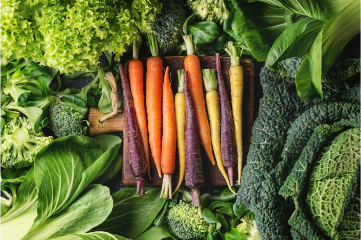 An image of vegetables including broccoli, carrots, kale and lettuces