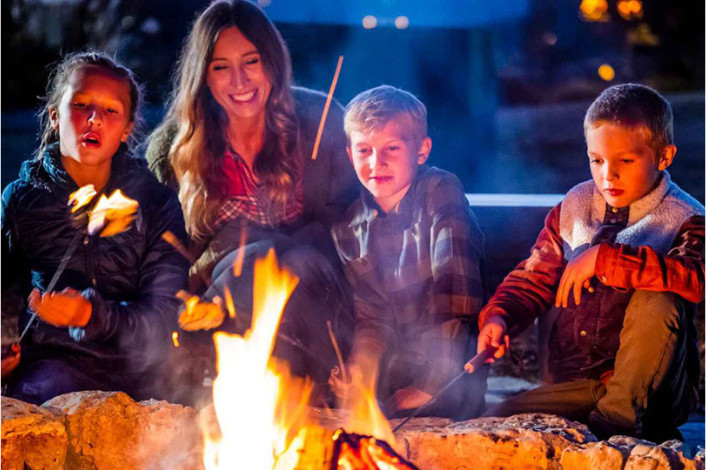 people roasting marshmallows over a fire