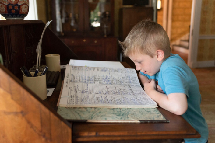 Child looking at historic book