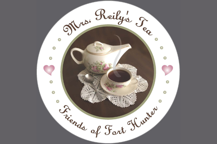 teapot and teacup sitting on a lace doily