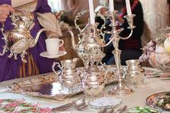 Victorian Tea 706 x 470 Costumed Attendant pouring tea from a silver teapot at an elegant table