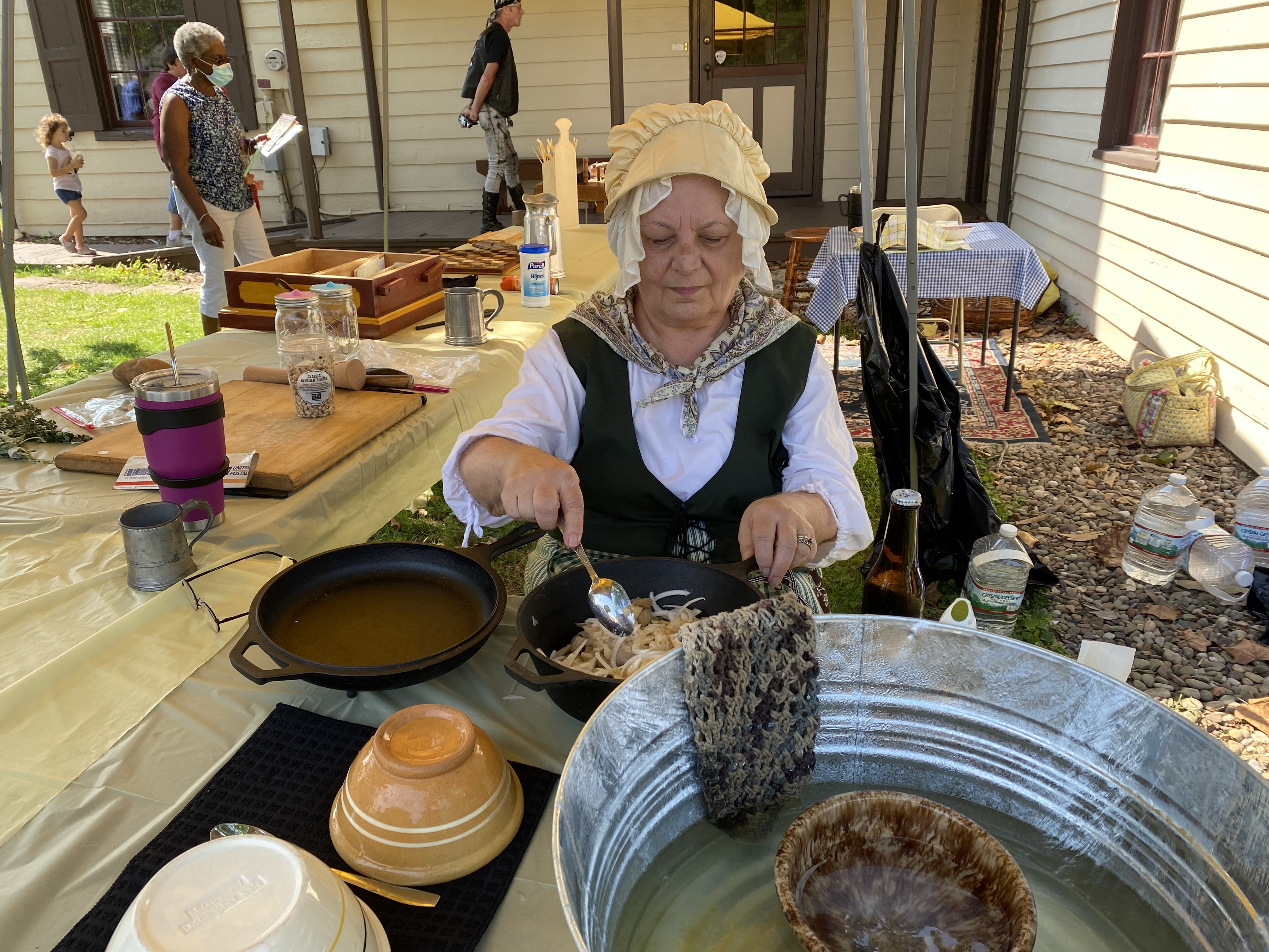 Person cooking in historical clothing