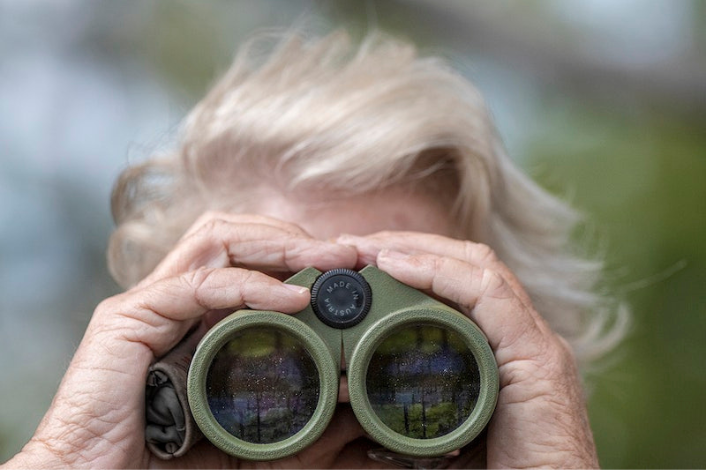 Woman looking through binoculars