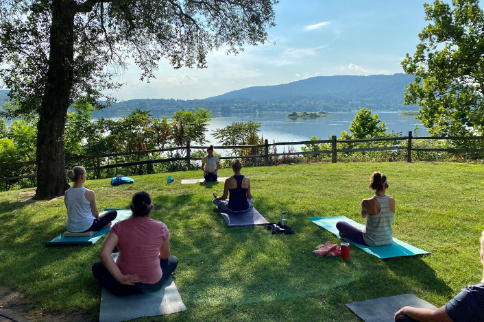 Outdoor yoga class with participants looking out over the Susquehanna River