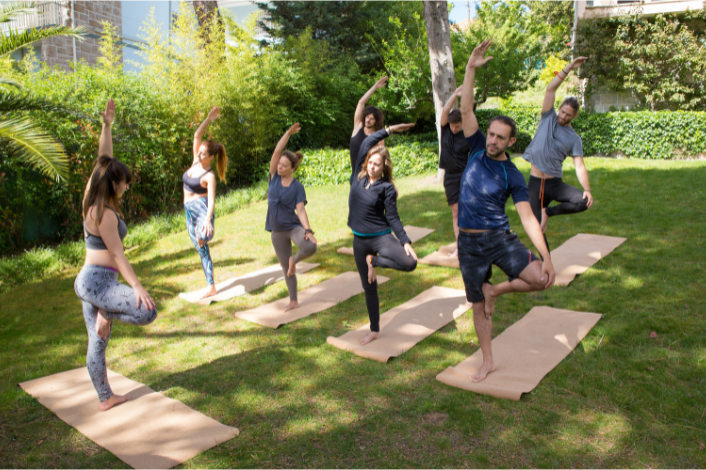 Outside class of yoga with participants standing
