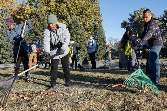 People raking leaves