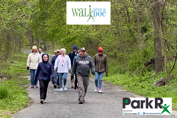 Group Walking on paved trail with trees around them