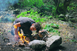 A man starting a fire outside