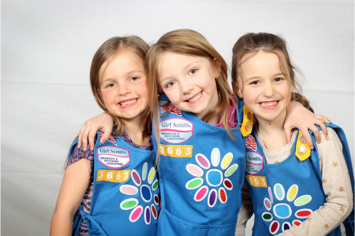 3 Daisy Scouts in their uniforms