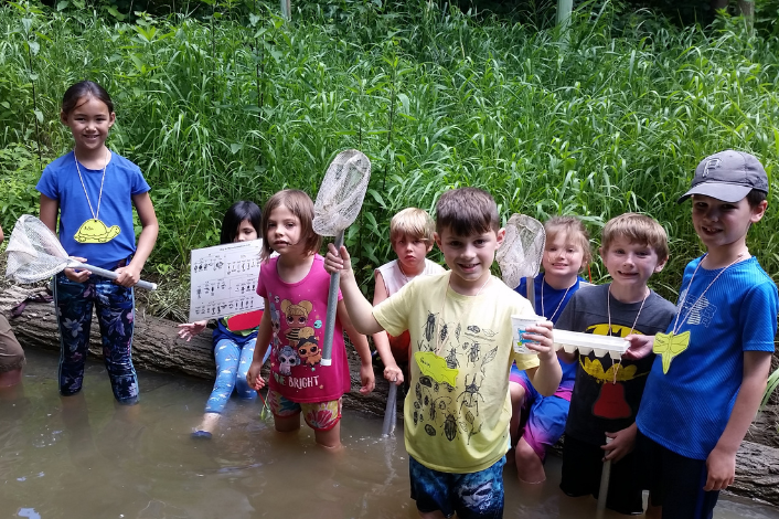 Children with nets in a creek