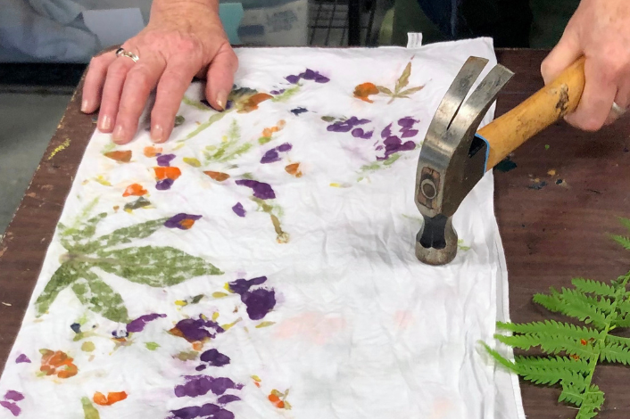 Flowers and other plant material being used to color fabric