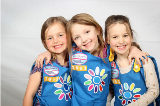 3 Daisy Scouts in their uniforms